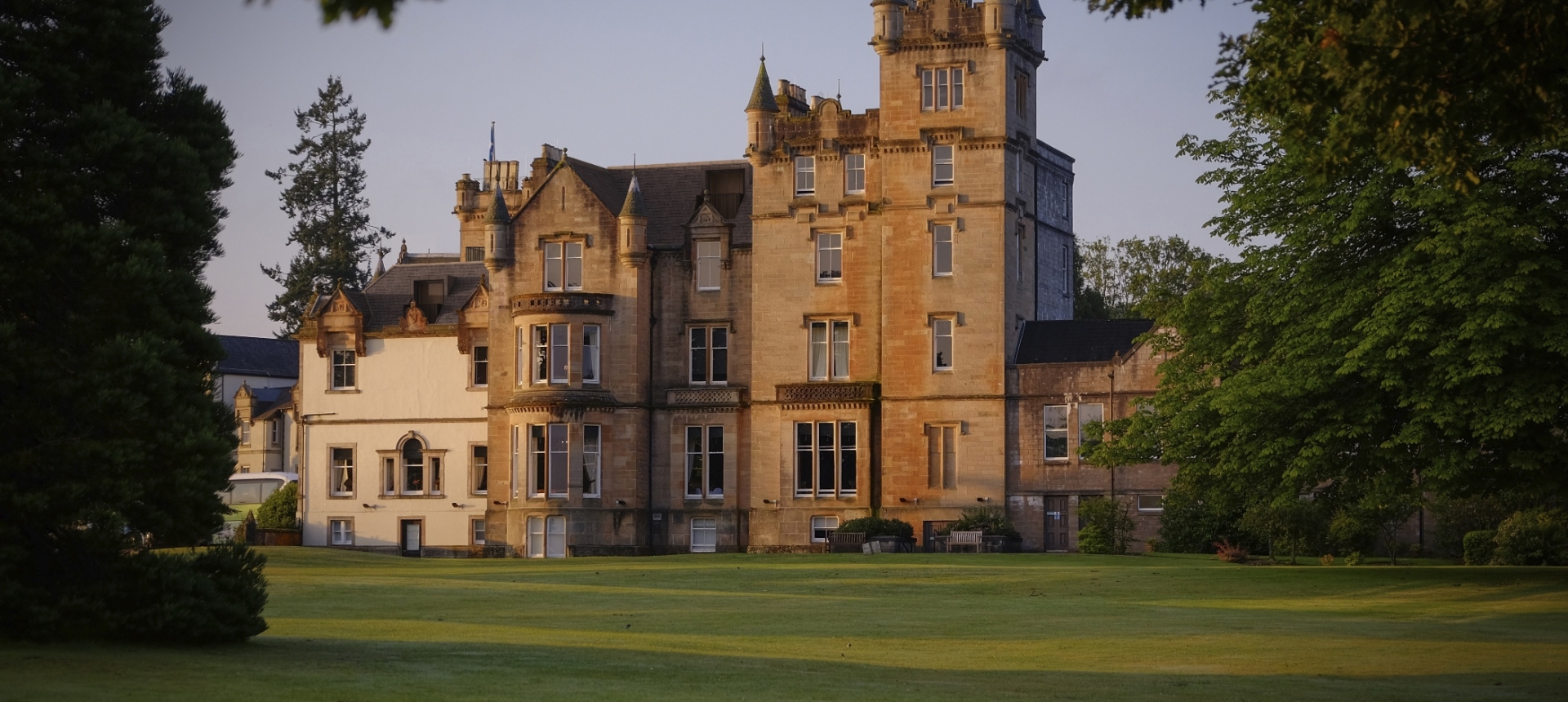 The Cameron House building with a lush green lawn in front