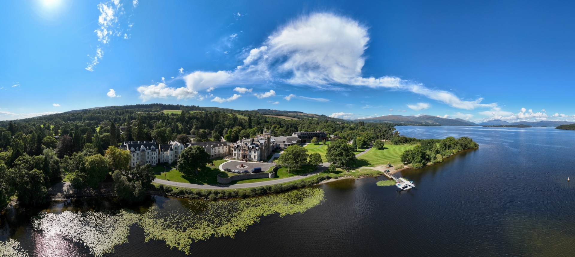 Aerial view of cameron house showing the beautiful green hotel grounds and the blue waters of Loch Lomond