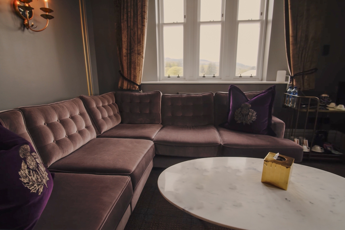 The seating area in the Tower Suite with a large sofa and white coffee table.