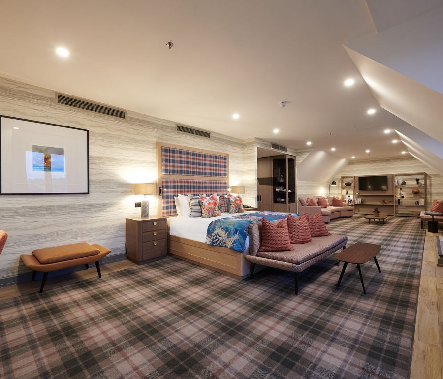 a large open bedroom with a bed and sitting area