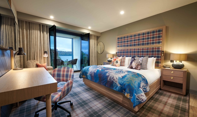 a bed room with a desk and a patio leading to the out side