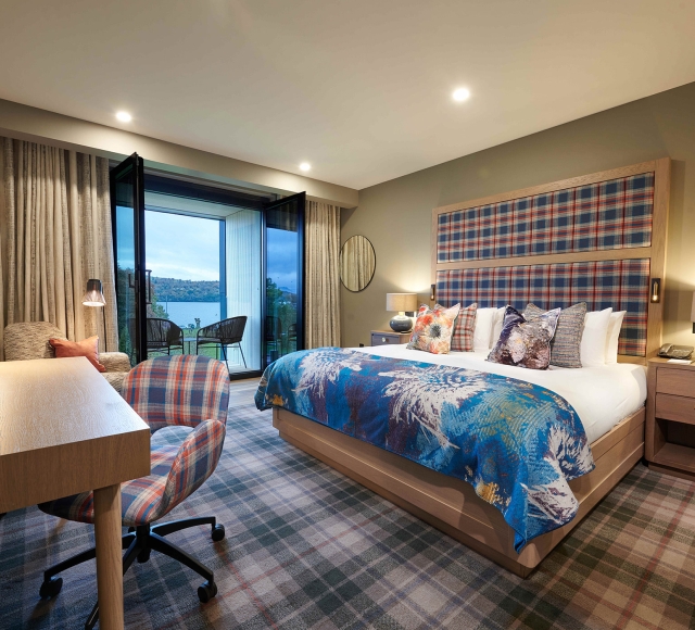 a bed room with a desk and a patio leading to the out side