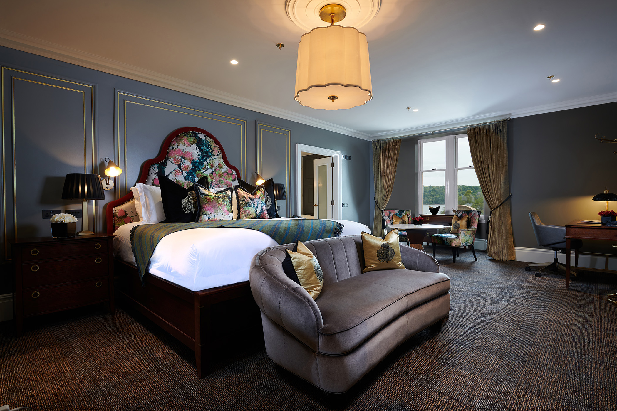 a large bed room with floral patterns on the head board of the bed