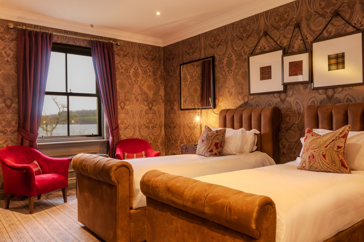 Hotel room with twin beds and a window at Cameron House, Loch Lomond.
