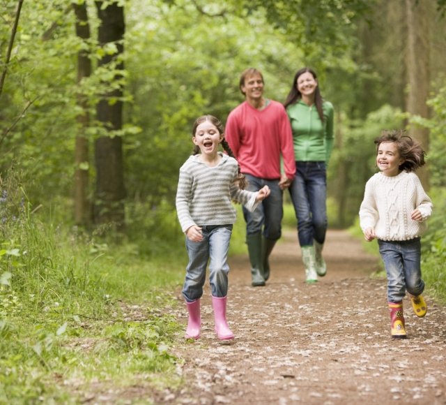 Family of 4 walking through forest in Loch Lomond