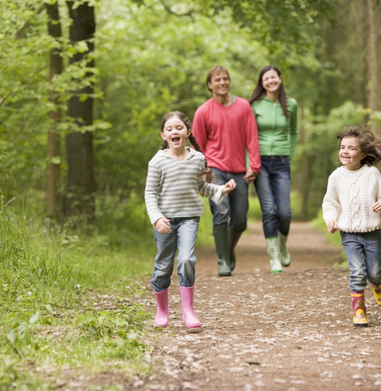 Family of 4 walking through forest in Loch Lomond