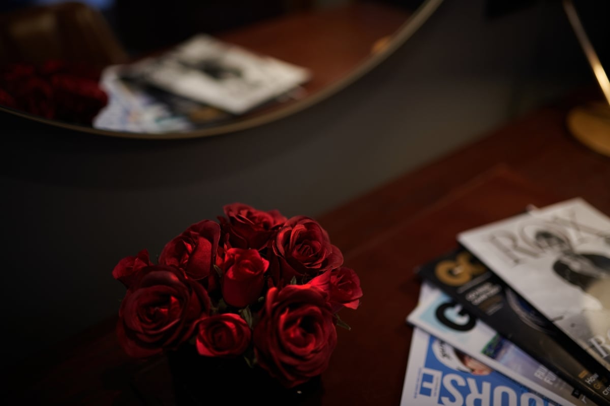 Red flowers on a table with magazines