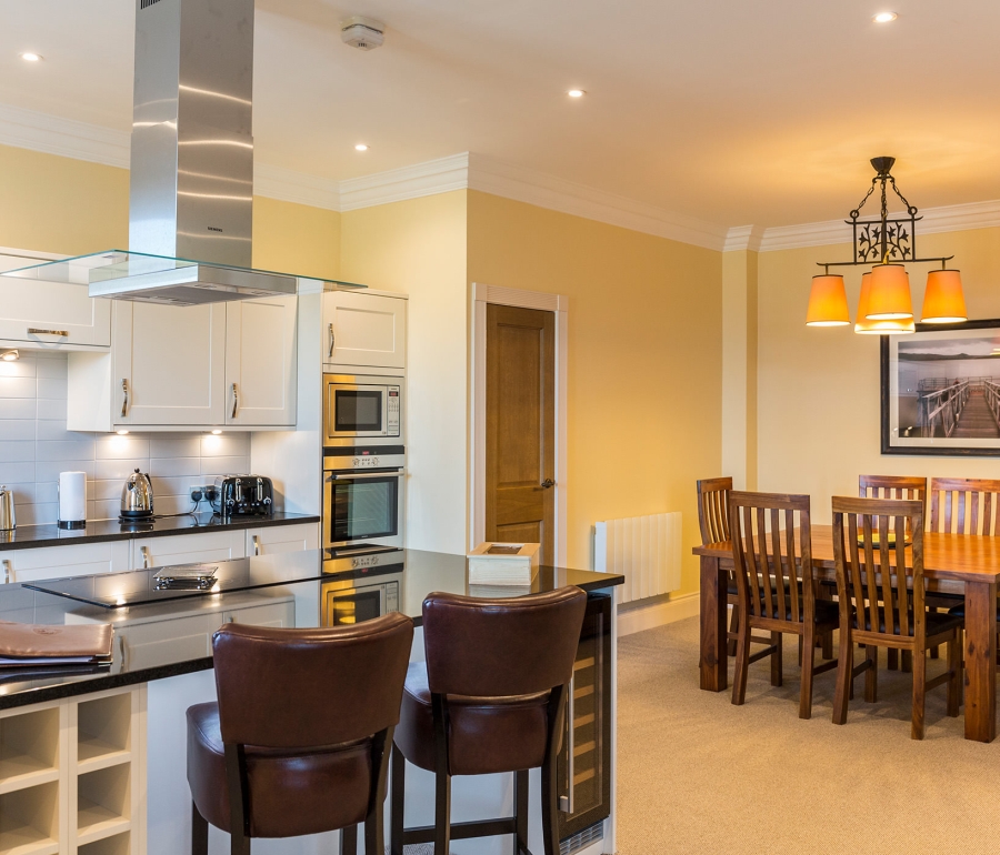 a kitchen area with a dining room table and a central island