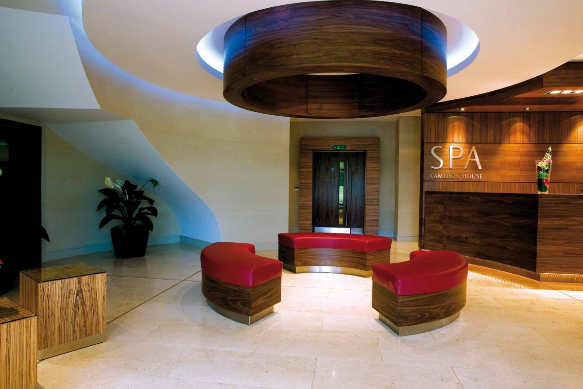 the front lobby of the cameron house spa with red seats in the middle of the room