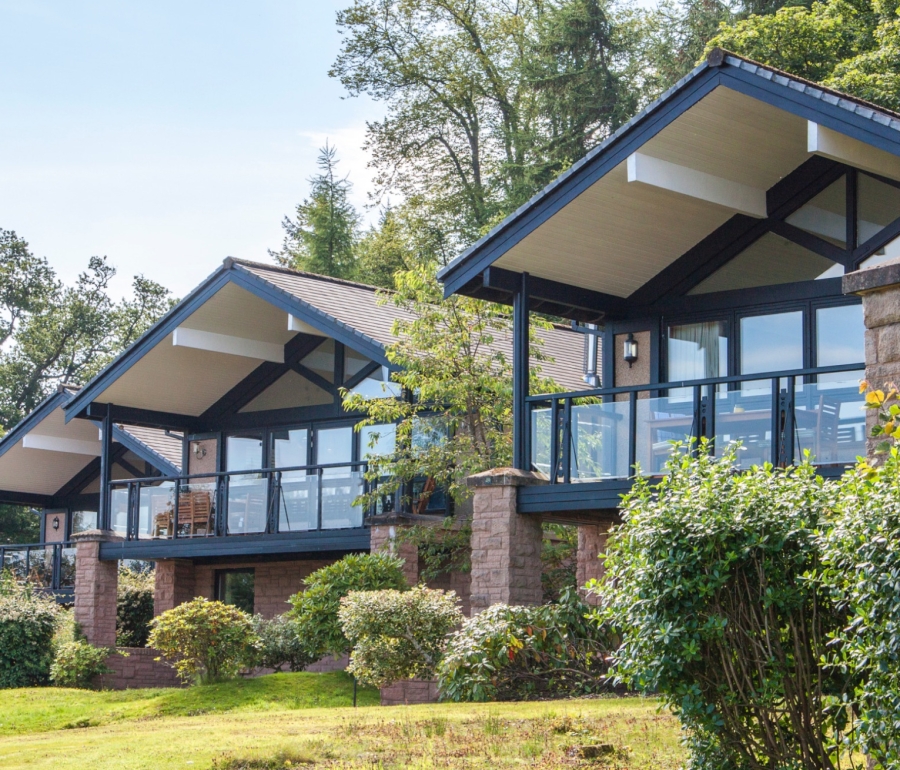 Exterior of the Cameron Lodges with lush green lawns and bushes in the foreground