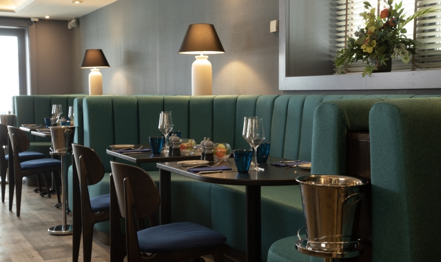 A spacious restaurant with a comfortable booths at La Vista, perfect for gatherings and shared meals.