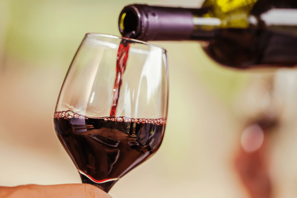 red wine being poured into a glass