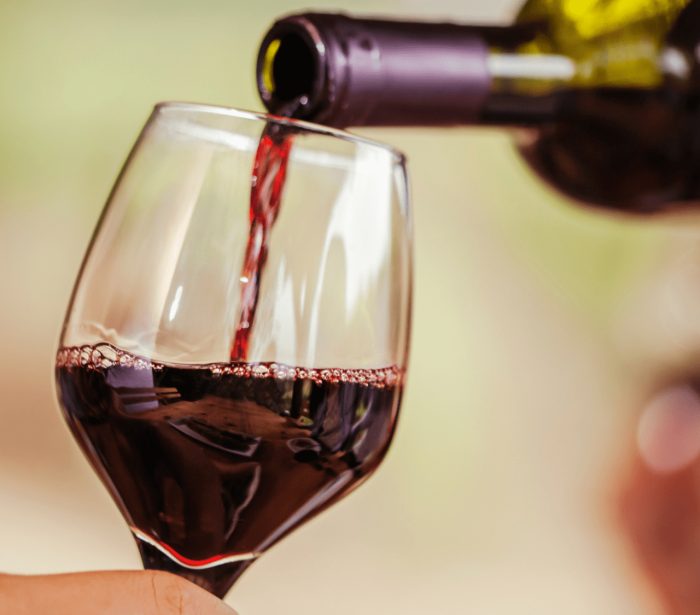 red wine being poured into a glass