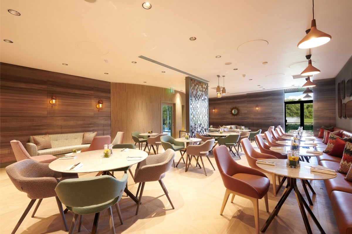 multi color chairs surrounding tables in a dining room at the spa