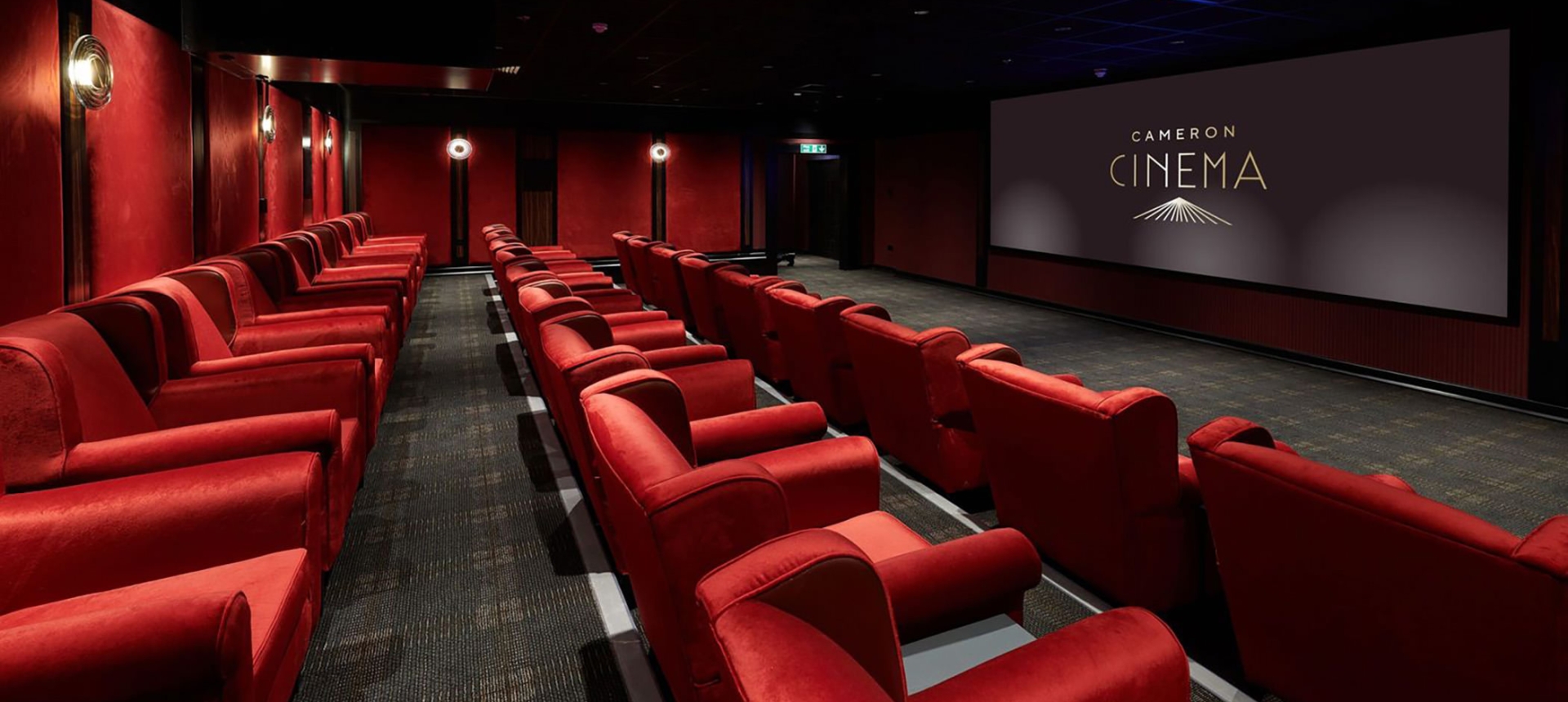 Cameron cinema located in Cameron house with rows of seating available