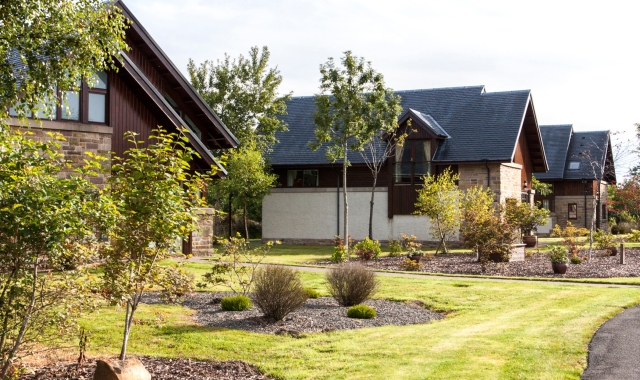 exterior view of lodges with trees in the front yard