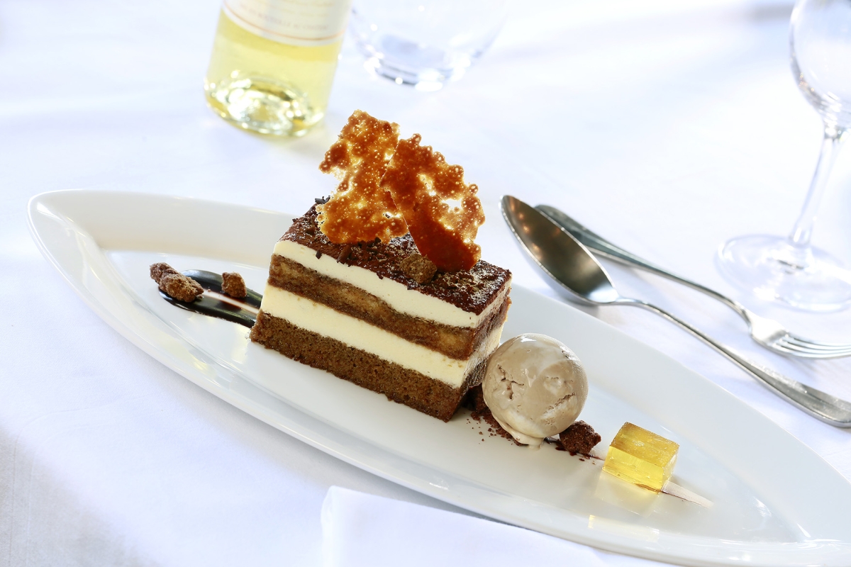 a small piece of cake sitting on a plate with silverware next to it