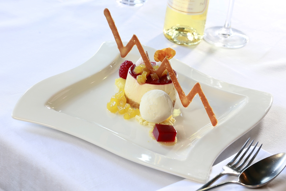 dessert sitting on a plate with colourful sides around it