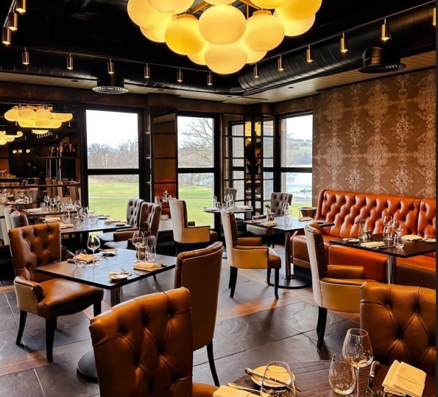 dining room with brown tables and chairs and bright lighting fixtures