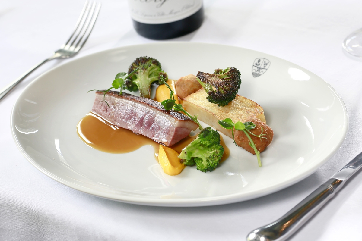 grilled tuna sitting on a plate with broccoli