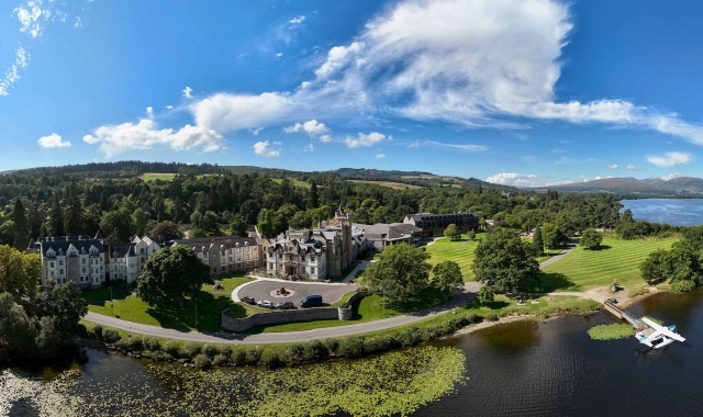 a birds eye view of cameron house showing the water and trees surrounding the property