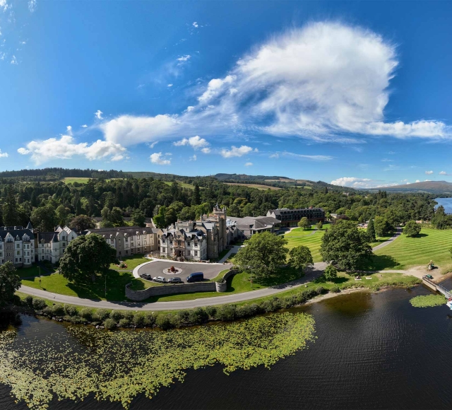 a birds eye view of cameron house showing the water and trees surrounding the property