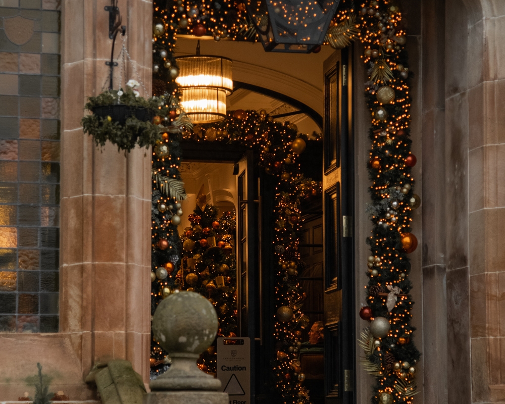 An impressive Christmas garland with Christmas lights at the entranceway to Cameron House
