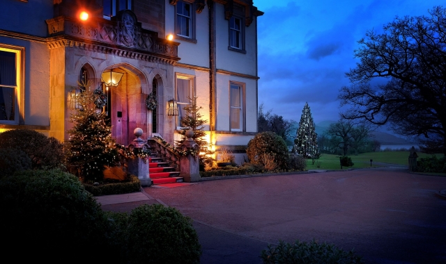 Exterior of Cameron House adorned with twinkling lights on the front steps, creating a festive ambiance for Christmas.