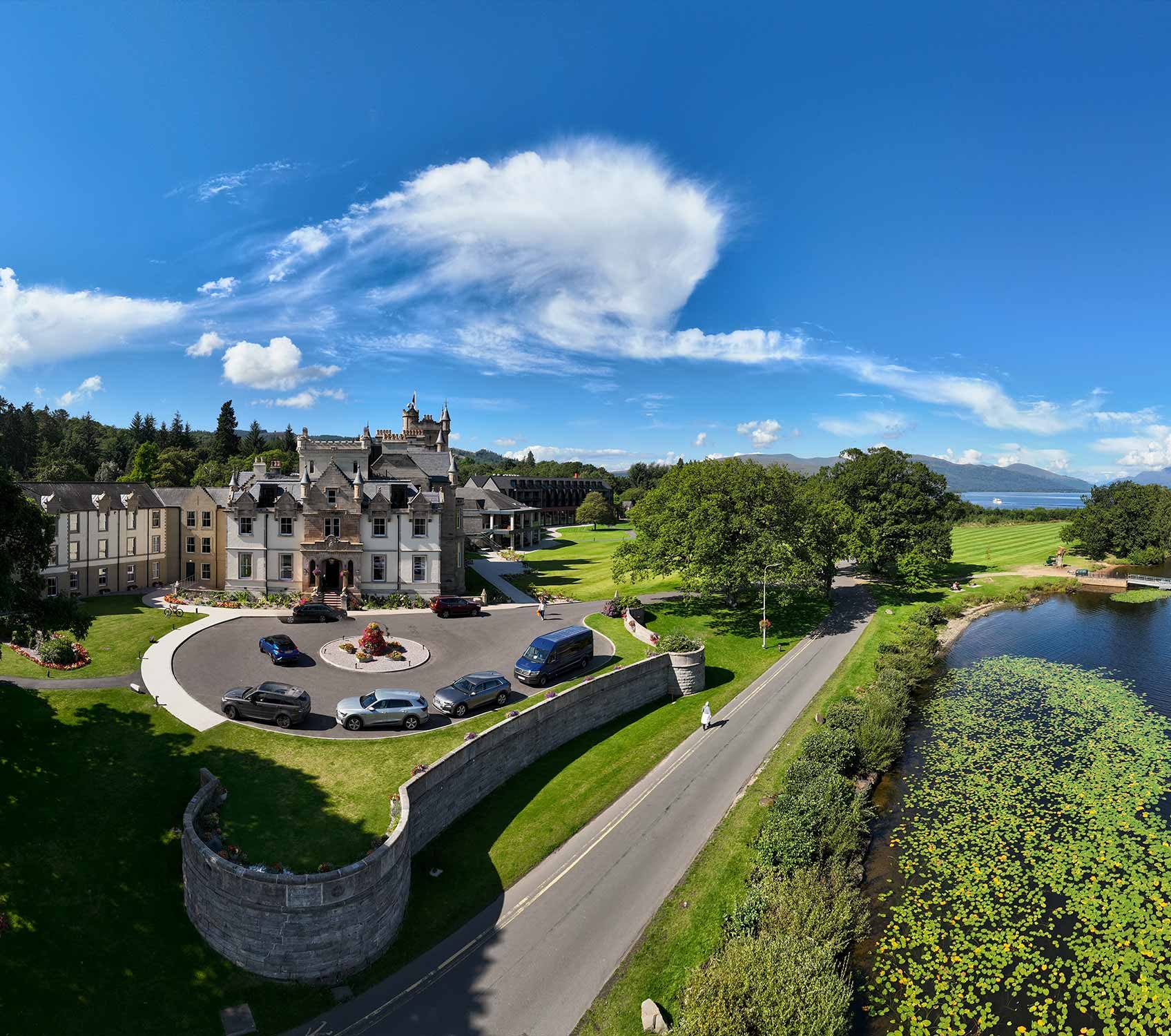 birds eye view of cameron house and its surroundings on a beautiful day