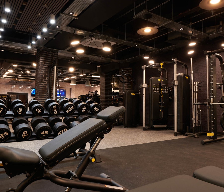 a weight bench set up with weights to the side on a rack