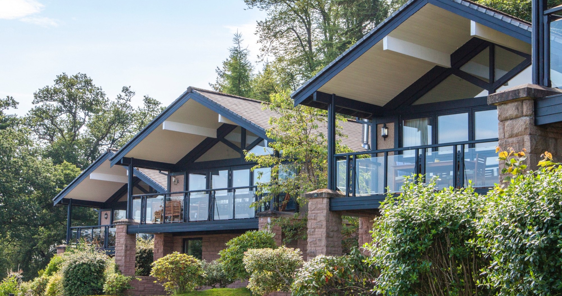 Exterior of the Cameron Lodges with lush green lawns and bushes in the foreground