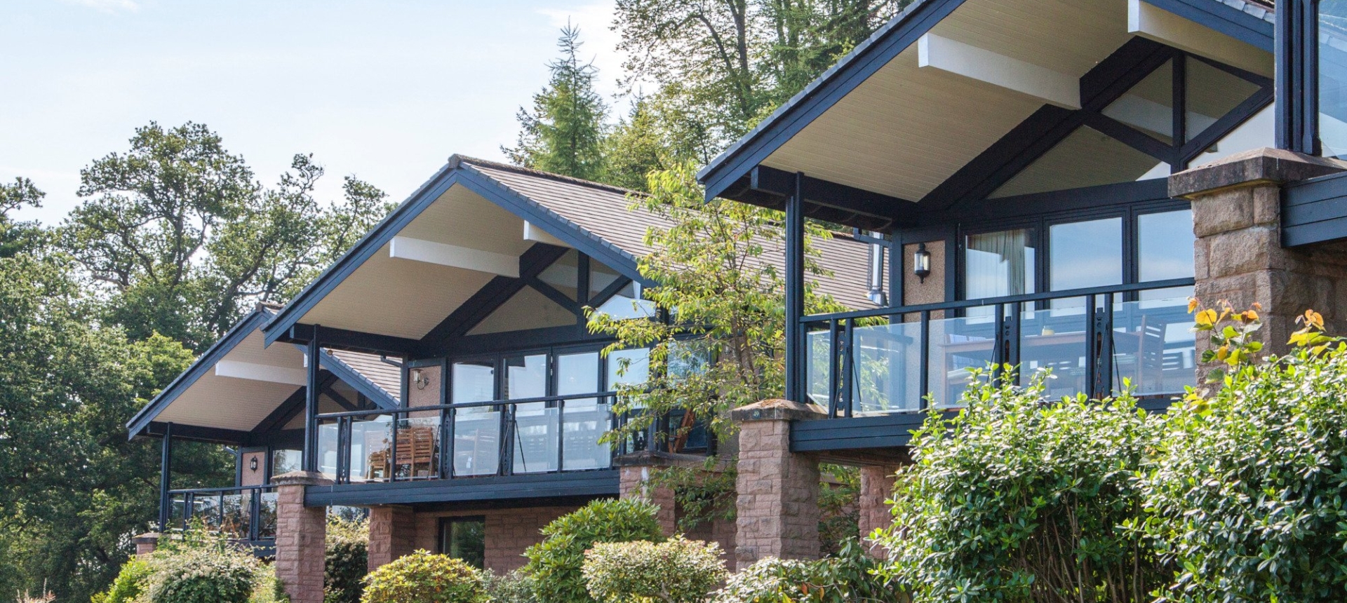 Exterior of the Cameron Lodges with lush green lawns and bushes in the foreground