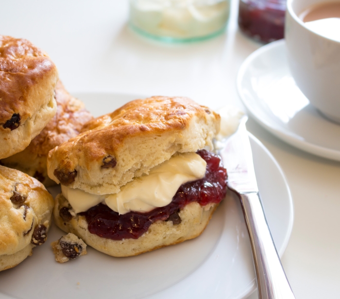 a plate full of scones covered in jam