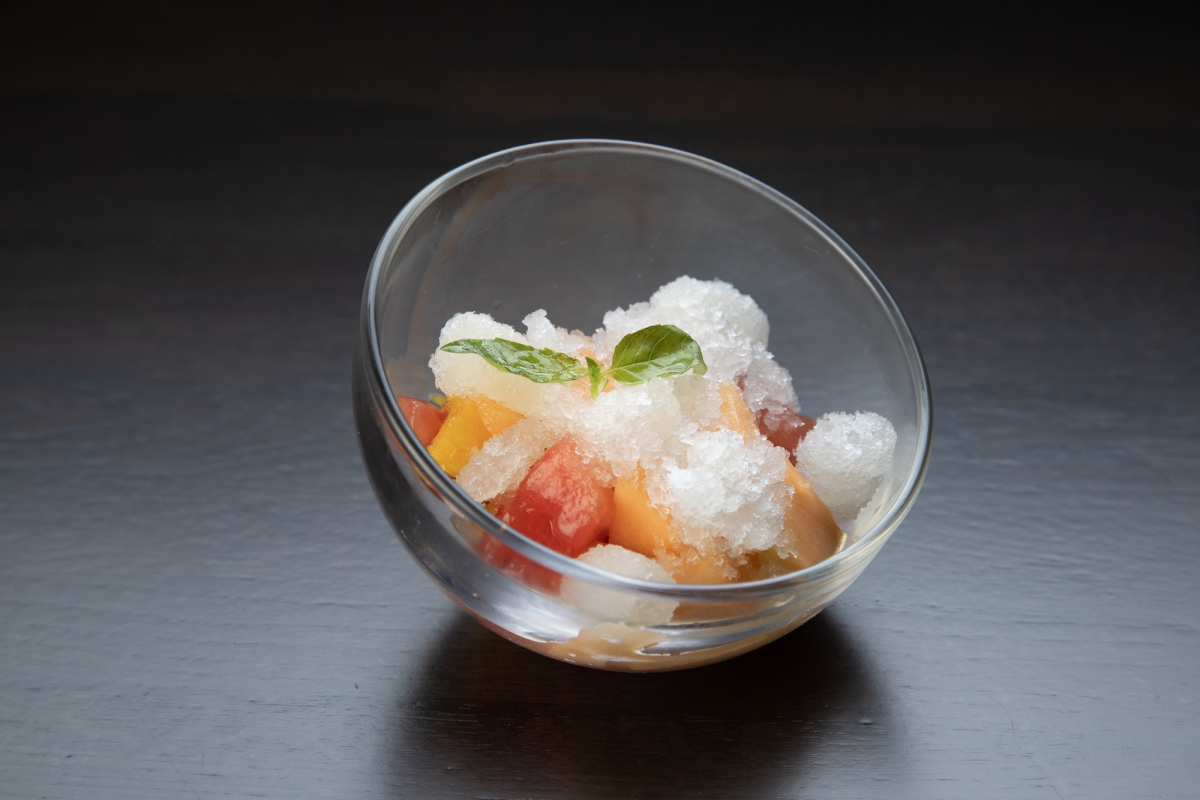 A delightful dessert at La Vista restaurant: a small bowl of fruit and ice on a table.