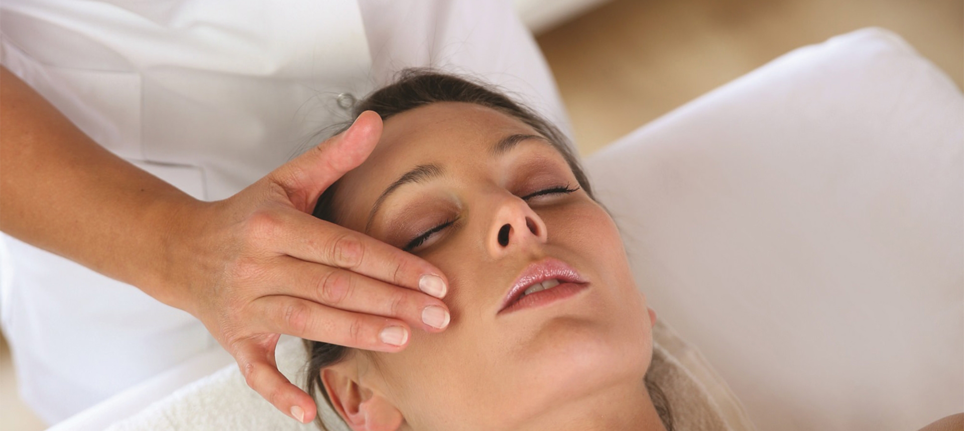 a woman at a spa getting some facial services done