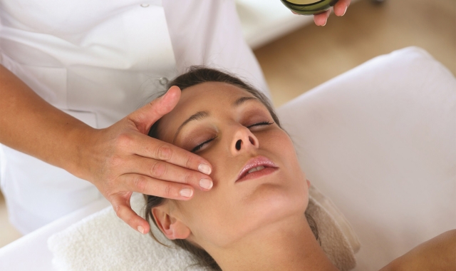 a woman at a spa getting some facial services done