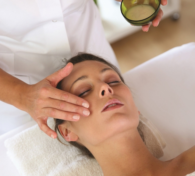 a woman at a spa getting some facial services done