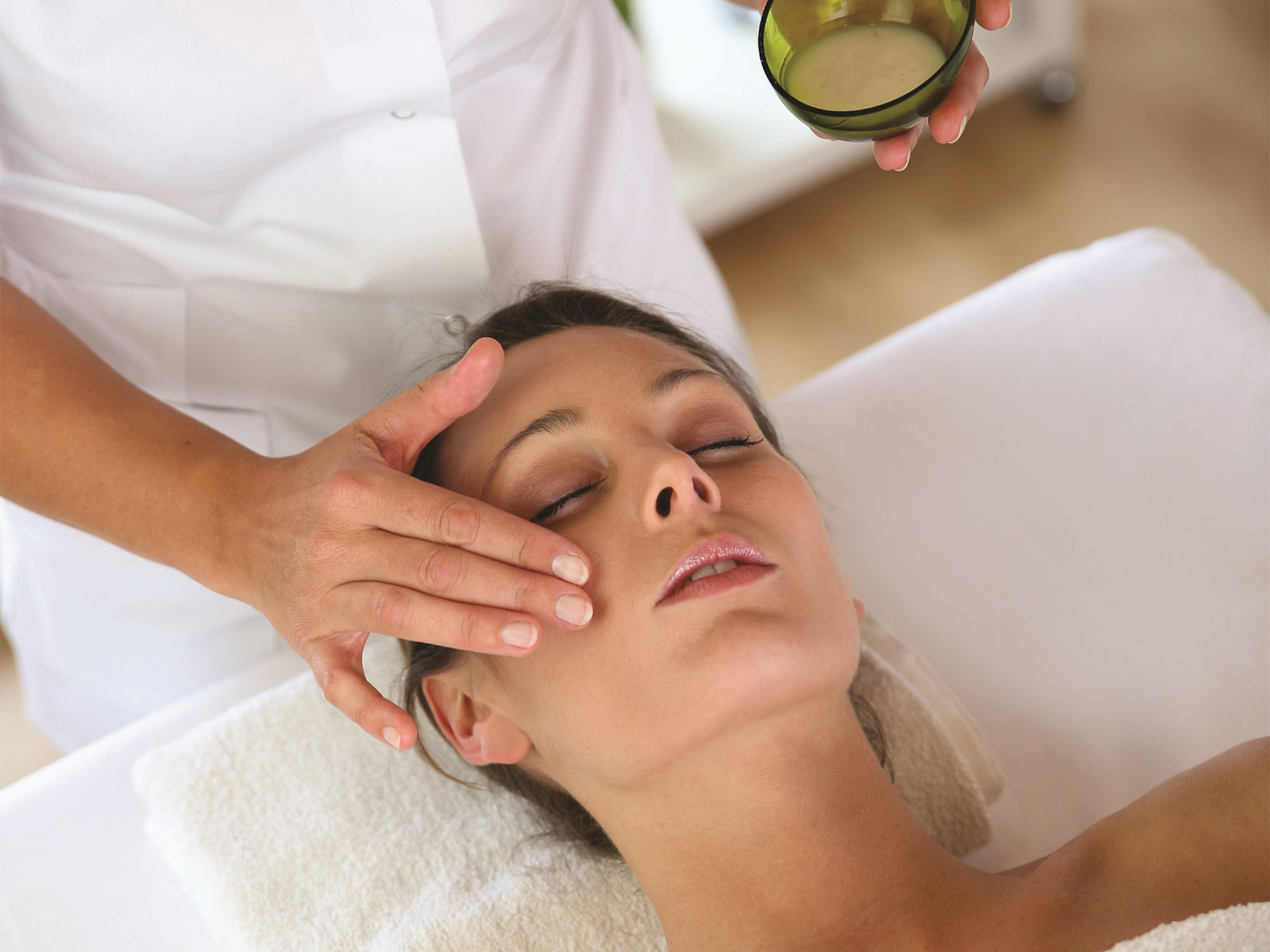 a woman at a spa getting some facial services done