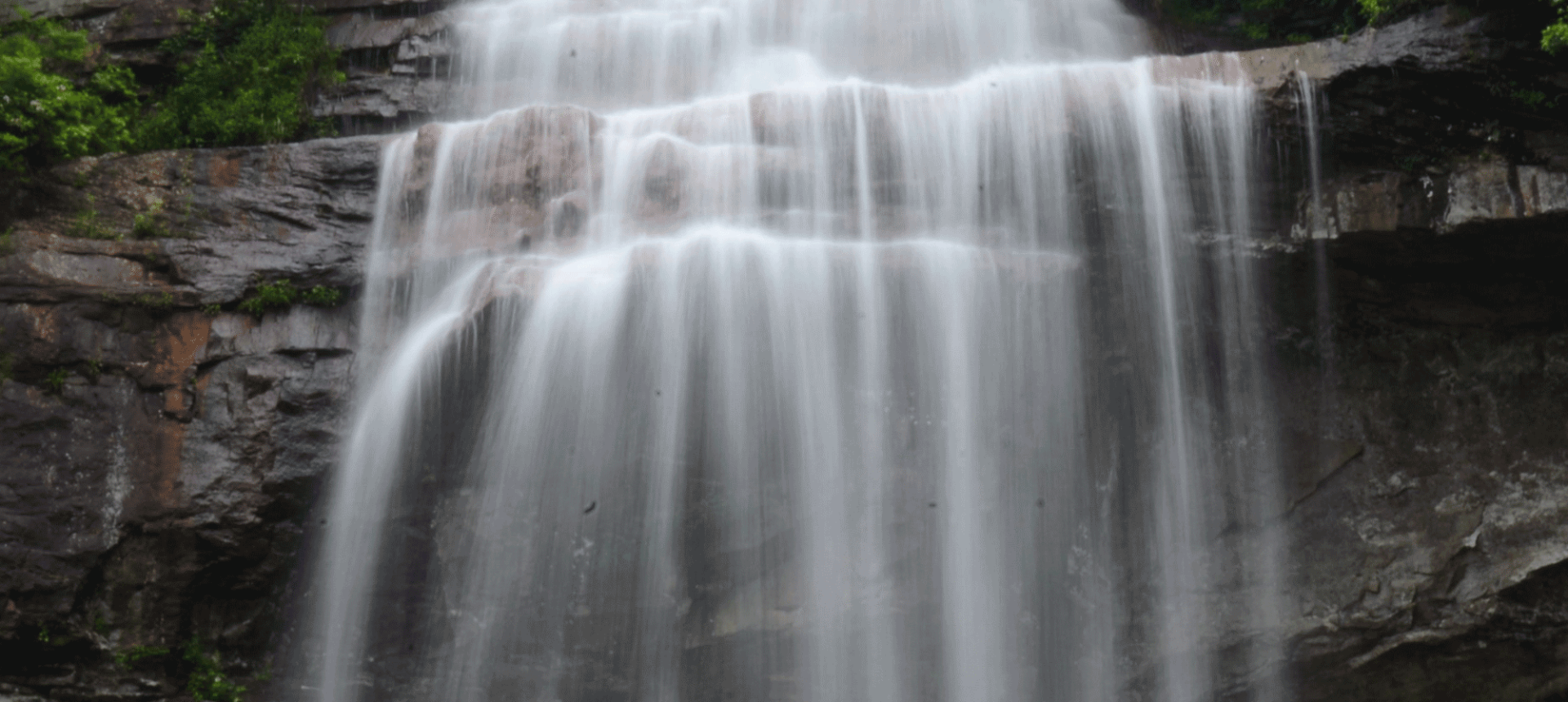 a close up view of water flowing down a water fall