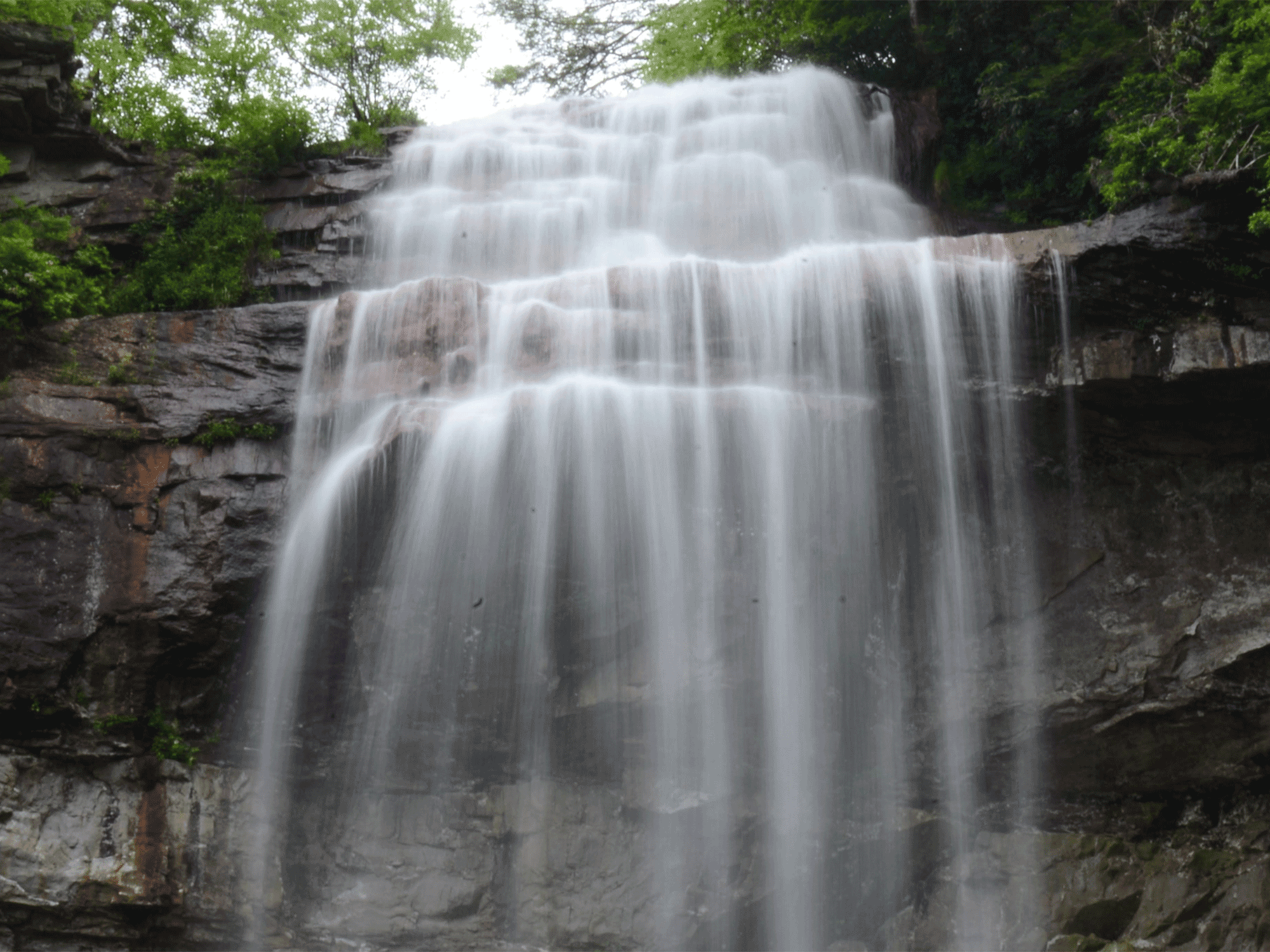a close up view of water flowing down a water fall