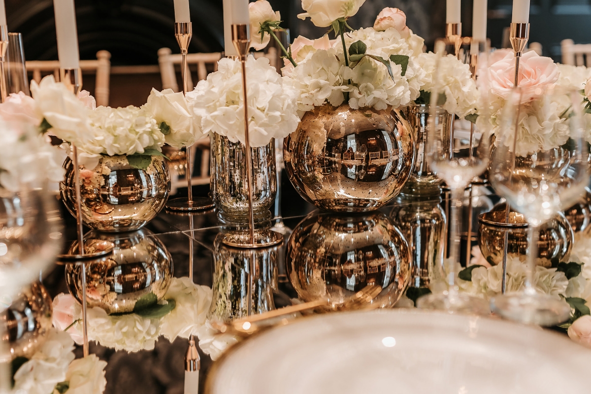 a beautiful center piece set up on a dining table with lit candles