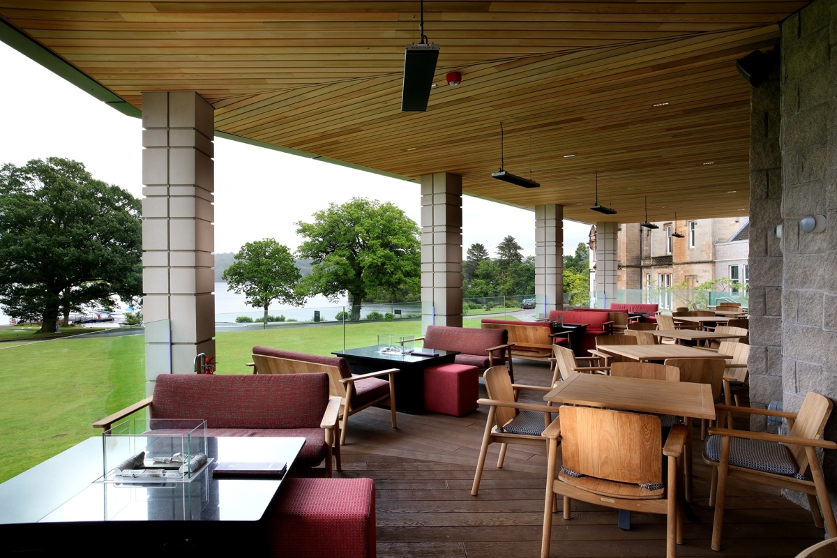 out door seating area with tables and chairs and great views of the water