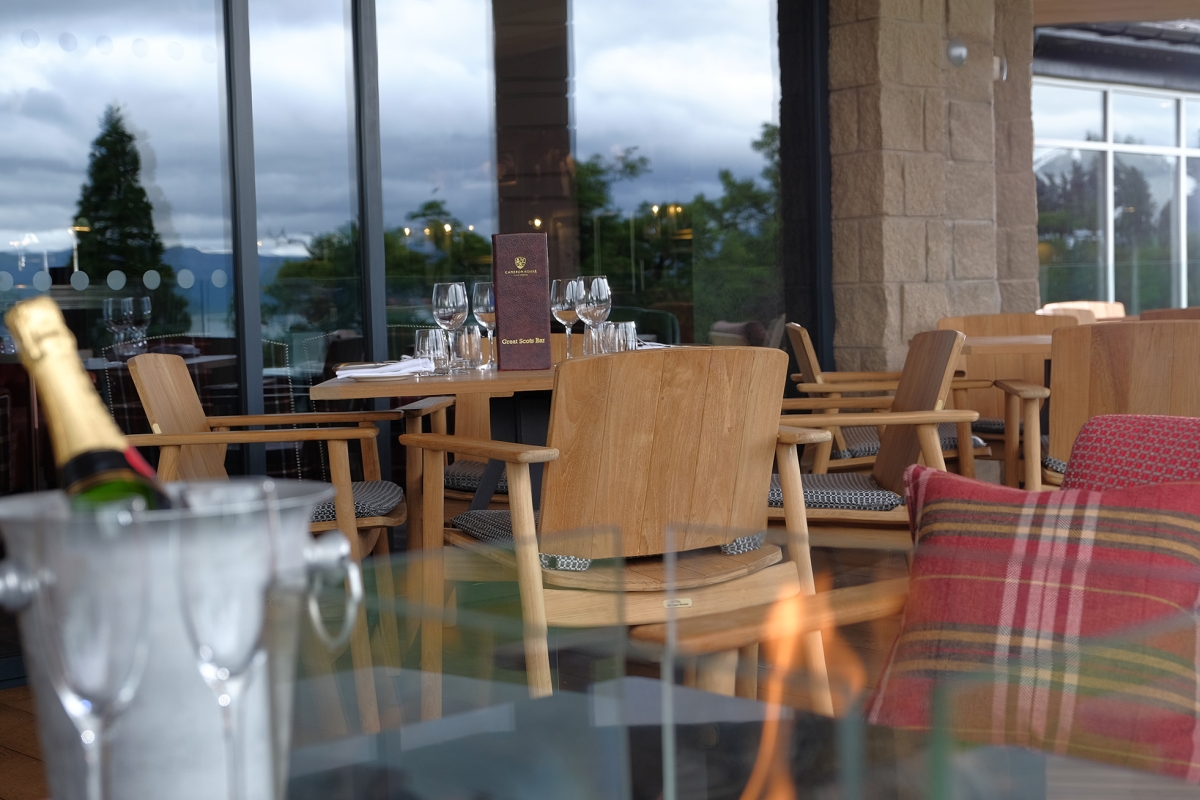 close up view of patio seating with a menu on top of the table