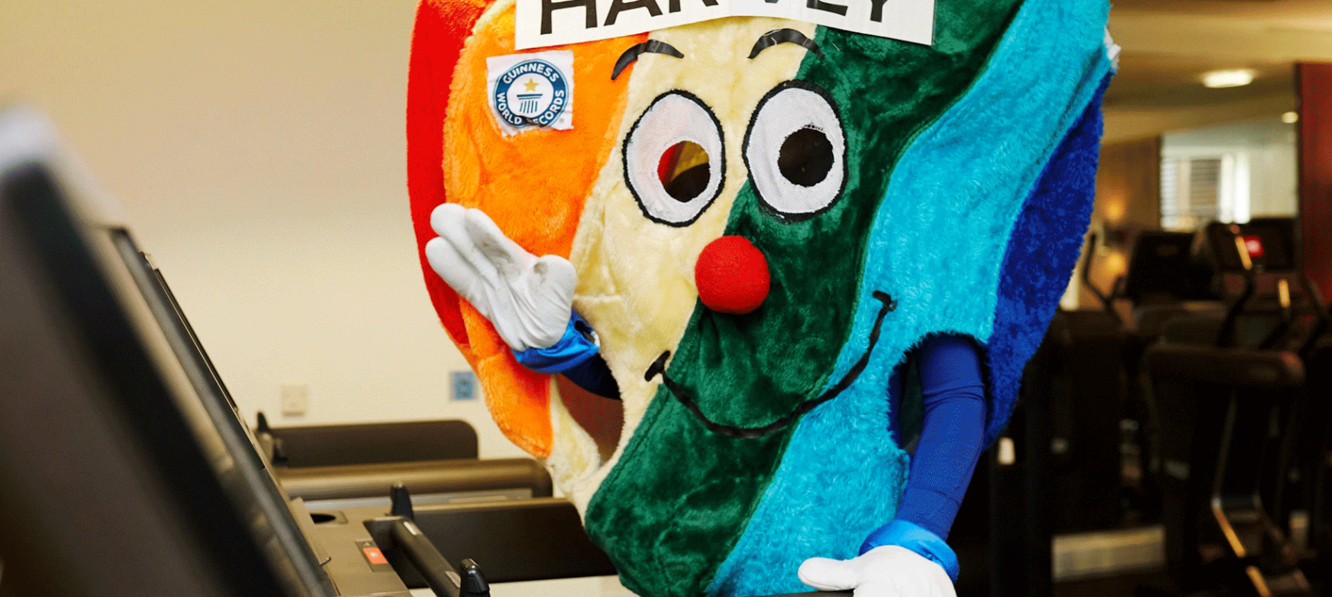 harvey the hospice heart standing on a treadmill waving
