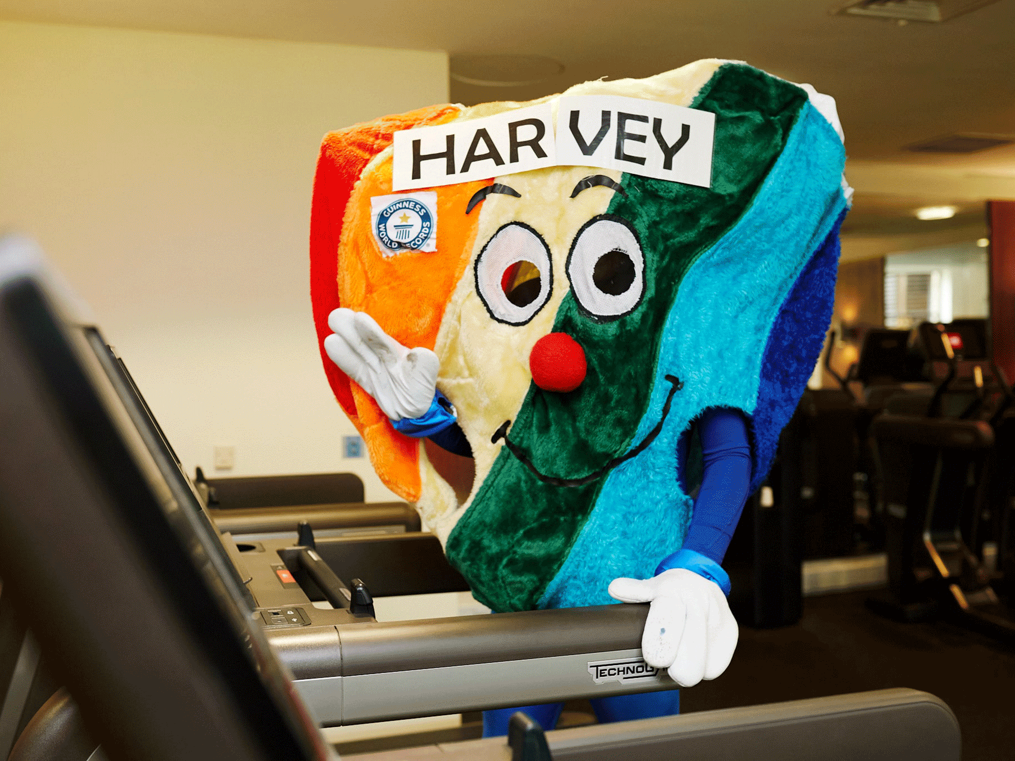 harvey the hospice heart standing on a treadmill waving