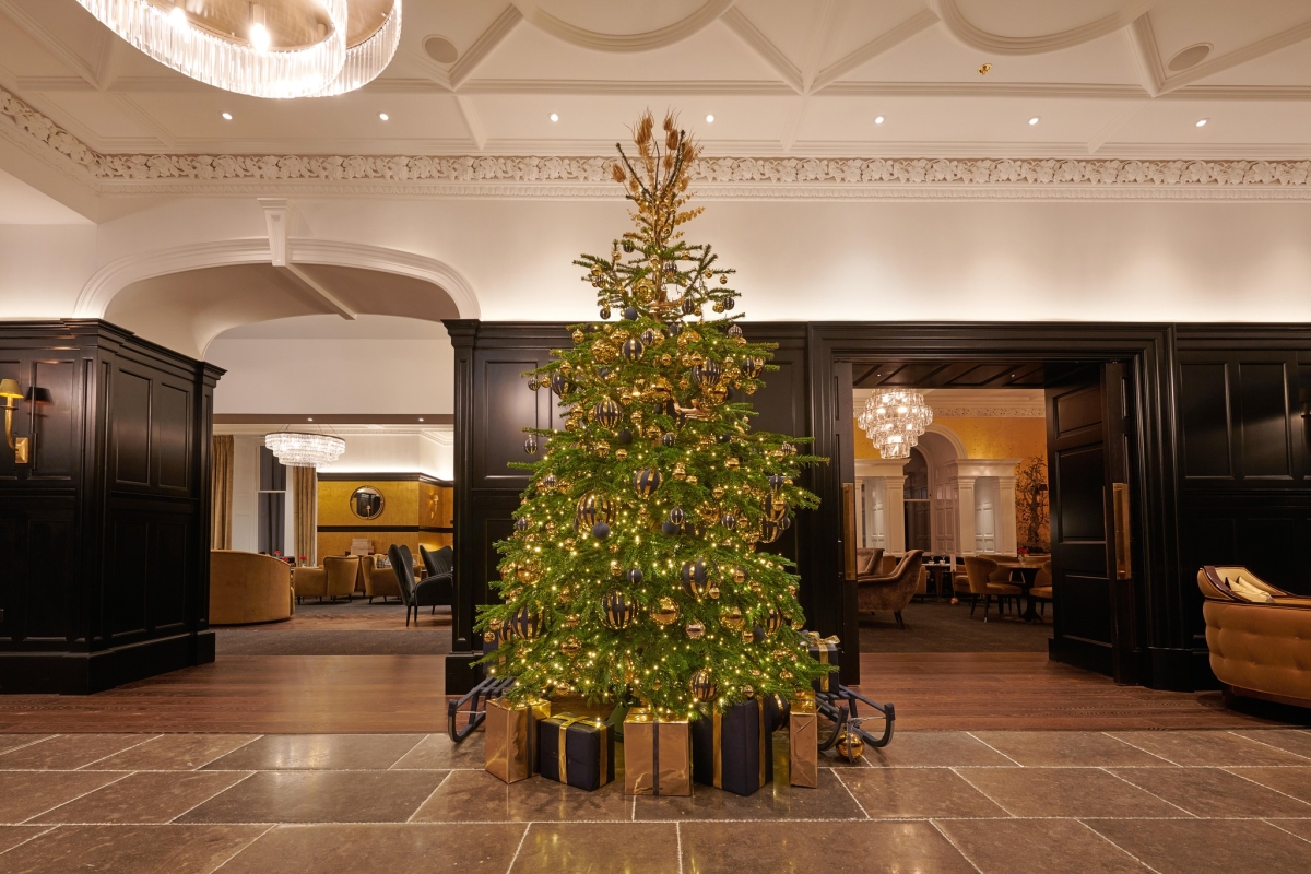 Festive Christmas tree adorned with colorful ornaments in the lobby of Cameron House.