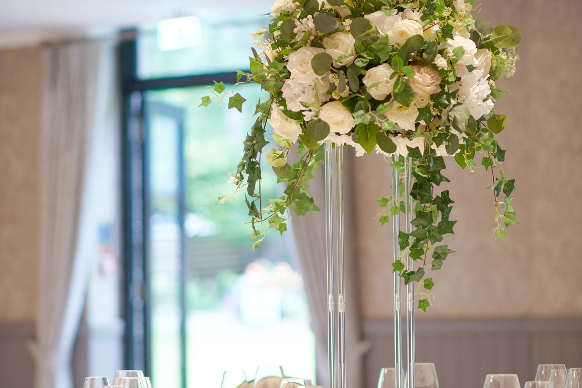 beautiful floral arrangement set up for a wedding on a white table