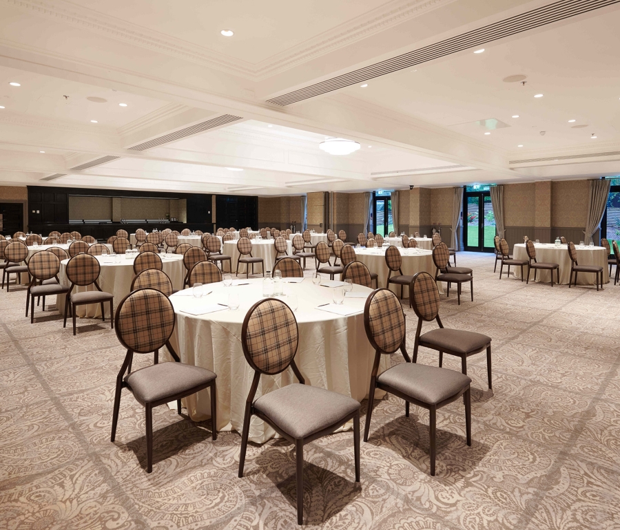 Elegant event space located inside Cameron House with lots of seating and silverware on the tables