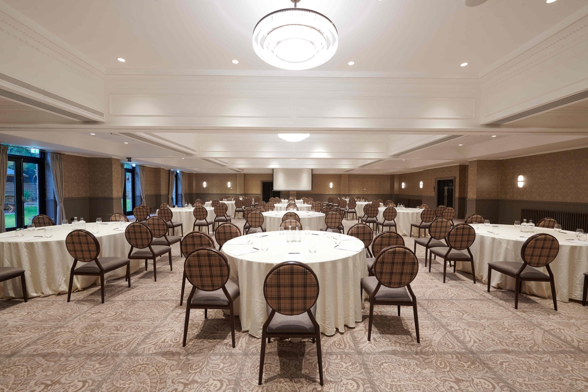 Large event space inside Cameron House with many tables and chairs for guests