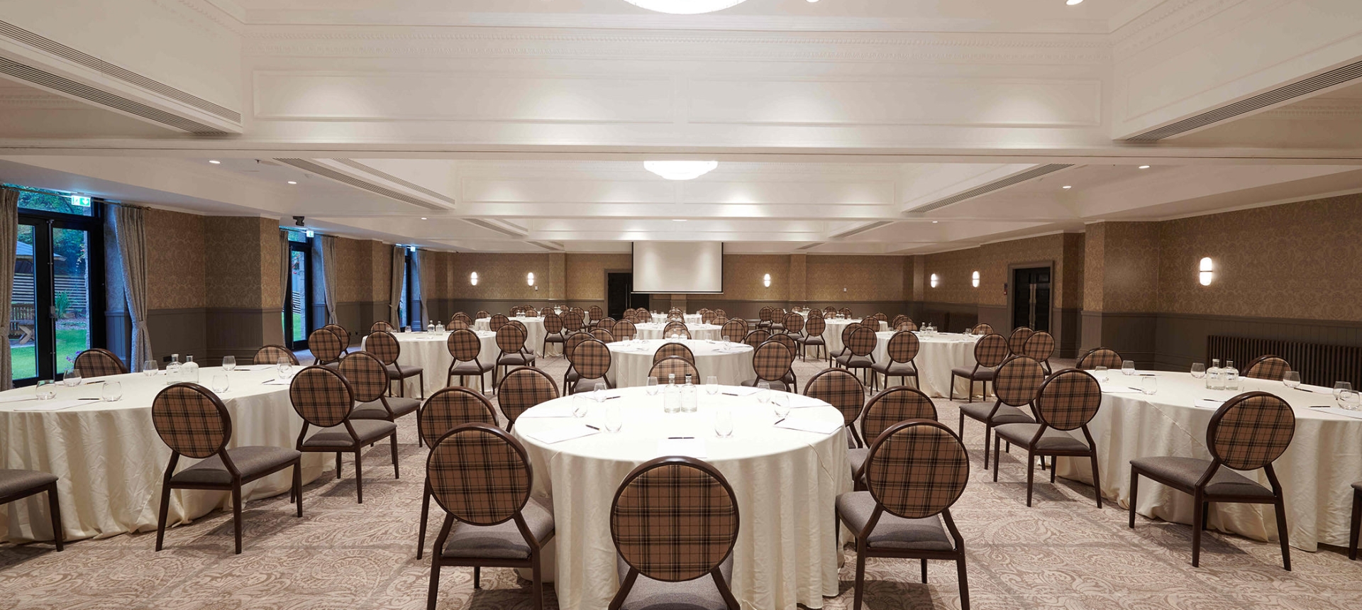 Large event space inside Cameron House with many tables and chairs for guests